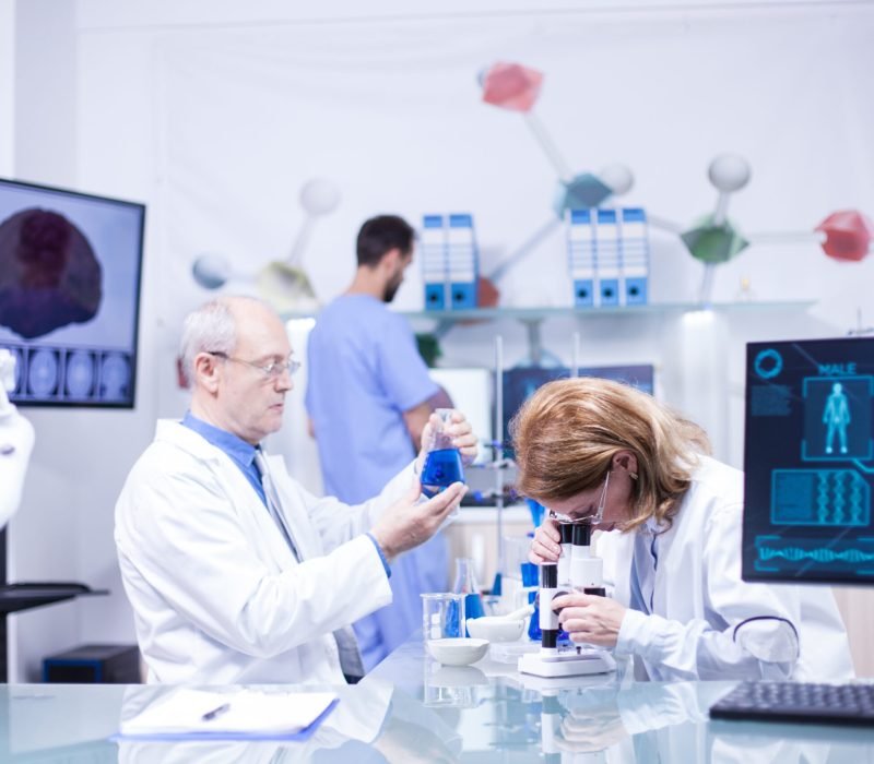 Groupe of researchers in pharmacology in a hospital laboratory. Modern equipment in research laboratory.